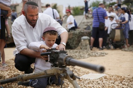 A Jewish toddler is taught how to launch missiles into Gaza.